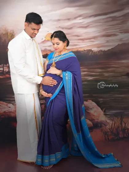 A classic Raja Ravi Varma-inspired studio portrait of a couple in traditional attire, creating a timeless and elegant image.