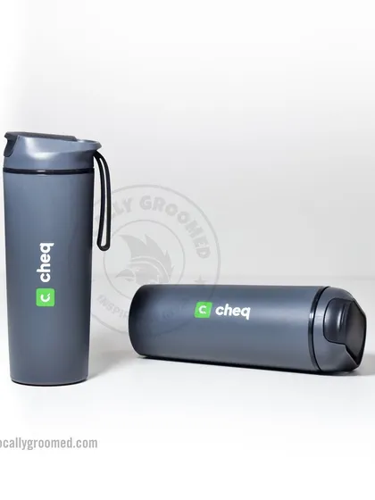 A sleek, grey travel tumbler with a secure lid and carrying strap, branded for our client Cheq. It's perfect for commuting and travel.