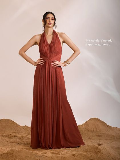 The Luna Dress stands as a testament to skillful craftsmanship, with its intricately pleated and expertly gathered silhouette designed for modern elegance.