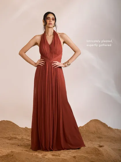 The Luna Dress stands as a testament to skillful craftsmanship, with its intricately pleated and expertly gathered silhouette designed for modern elegance.