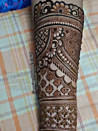 A full arm design with a mix of traditional Indian patterns, perfect for a bride.