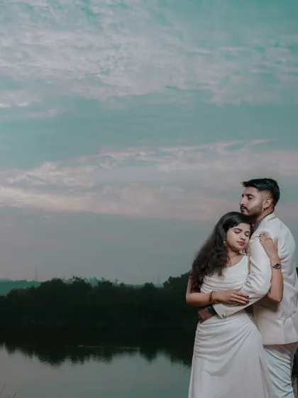 A quiet, intimate pre-wedding moment captured by the lake as the sun sets. We find the most serene natural locations for your photoshoot.