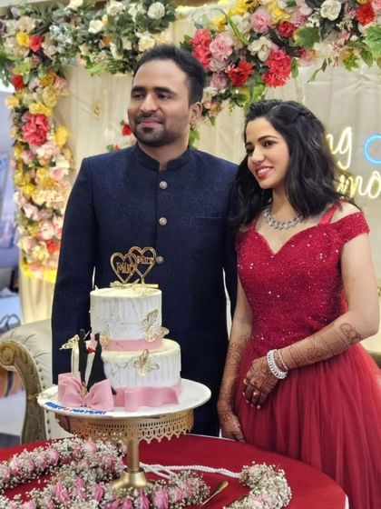 Another happy couple celebrating their ring ceremony. The bride's red gown with a sweetheart neckline is a romantic and classic choice for this special occasion.