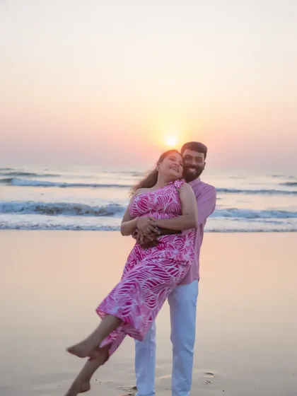 A playful and romantic pre-wedding moment as the sun sets over the ocean. Beach photoshoots like this are a wonderful way to capture your love in a relaxed, natural setting before the big day.