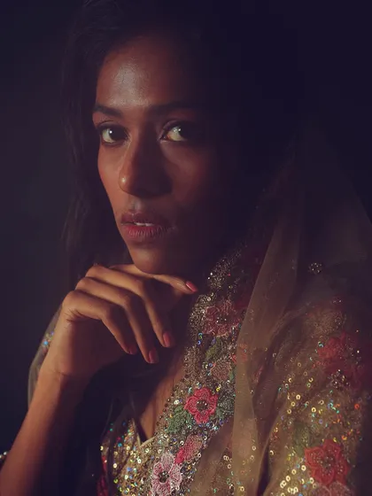 An elegant and soft portrait from a shoot with a floral lehenga. The makeup is minimal and fresh, with soft, open hair.