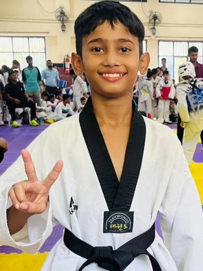 The smile of a champion after a hard-fought victory. This young black belt shows the joy that comes from discipline and dedication. This is why we do what we do.