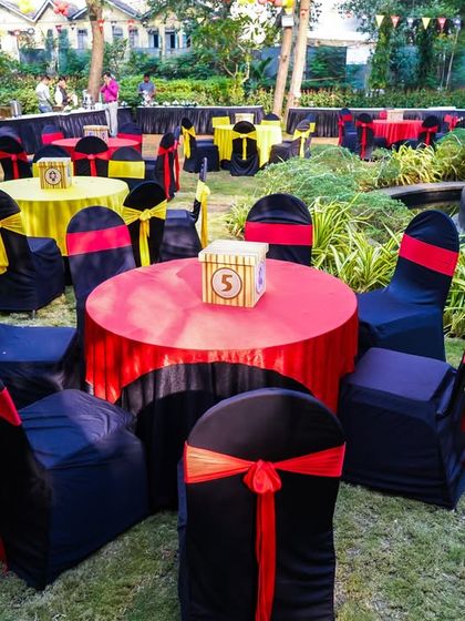 Outdoor seating for the pirate-themed section of the party, with tables dressed in red, yellow, and black.