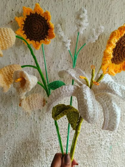 A gorgeous mix of my handmade flowers, including a white lily, sunflowers, and lily of the valley. This shows the variety you can choose from for a custom bouquet.