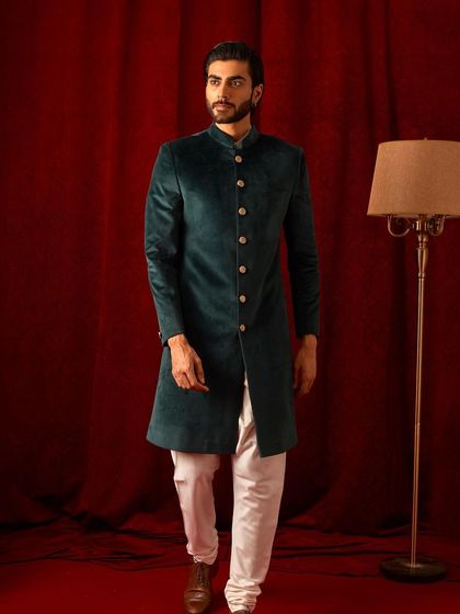A full-length shot of the green velvet bandhgala, showing its classic, tailored cut. This is a timeless piece that you will return to for years to come.