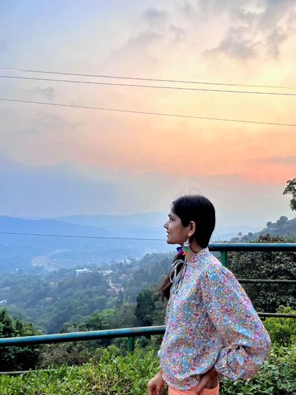 Looking out at the hazy mountains of Coorg at dusk. The soft, layered landscape is like a watercolor painting come to life.