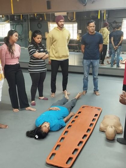 An instructor explains the recovery position during a first aid workshop. These skills are invaluable for client safety.