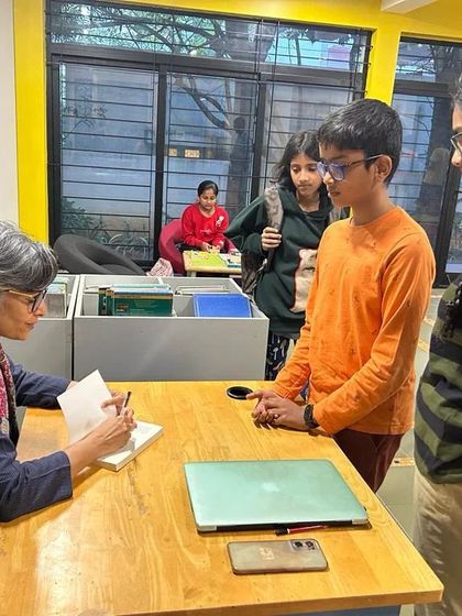 A close-up of young readers waiting eagerly as author Mandira Shah signs their books. These are the moments that create lifelong readers.