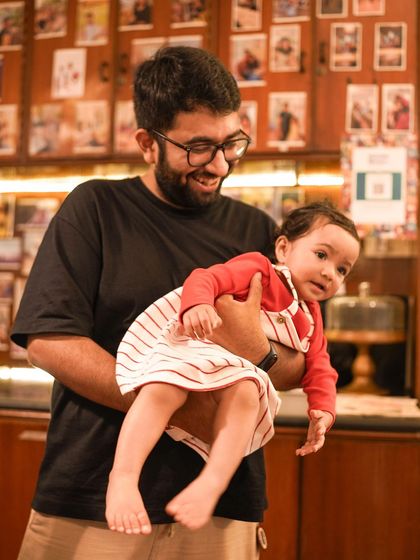 A participant holds a baby, showing that our events are welcoming for the whole family.