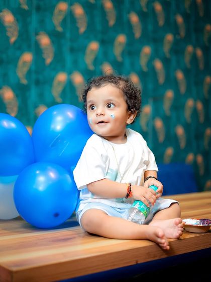 A little bit of cake on the face adds to the story. This photo captures the aftermath of a little treat during his first birthday session.
