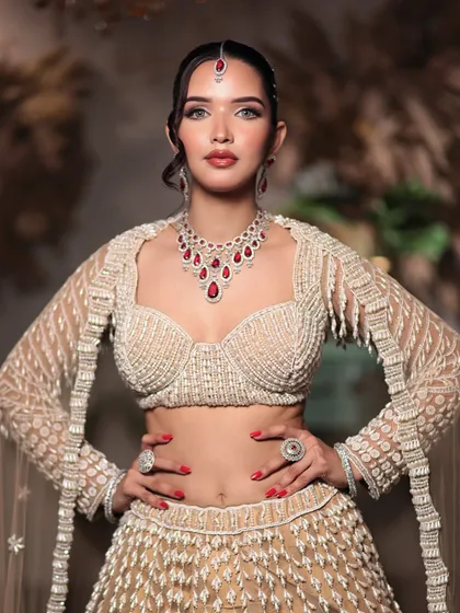 A full-length view of the stunning ivory and red engagement outfit, complemented by flawless makeup and a sleek, modern hairstyle.