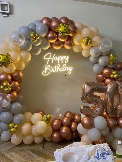 A close-up view of the 50th birthday balloon arch, showing the mix of different balloon sizes and star-shaped foil accents.