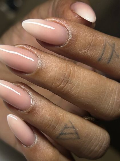 A beautiful baby boomer or ombré effect on long, almond-shaped gel extensions. The seamless transition from a soft pink base to a white tip creates a sophisticated and elongated look.