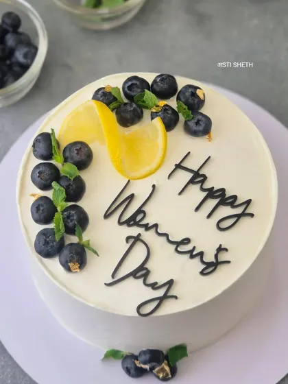A zesty and refreshing Blueberry Lemon cake for Women's Day, decorated simply with fresh blueberries and a lemon slice.