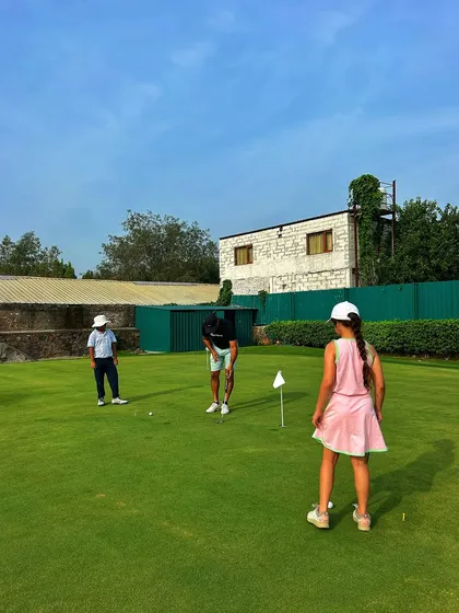 A family affair on the putting green. We love seeing parents passing on their love for golf to their kids.
