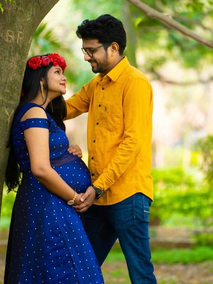 A tender moment between a couple under a tree. The natural setting adds a sense of peace and tranquility to this beautiful maternity shot.