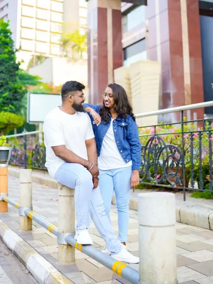 A sweet, candid-style photo of the couple on a city street. We capture the small, happy moments between you.