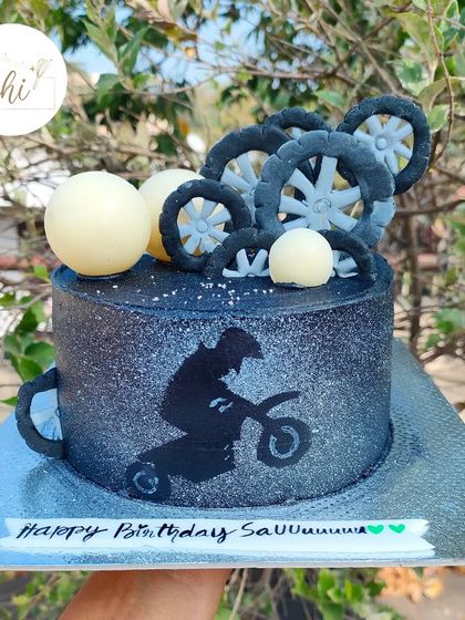 One of my recent favorites. This bike-themed cake uses a spray-painting effect to create a cool silhouette of a motocross rider against a glittery black background.