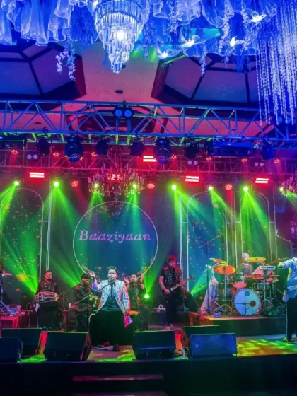 A stunning stage setup for a wedding event, with "Ishq ki Baaziyan" displayed on screen. We create the perfect ambiance for love and celebration.