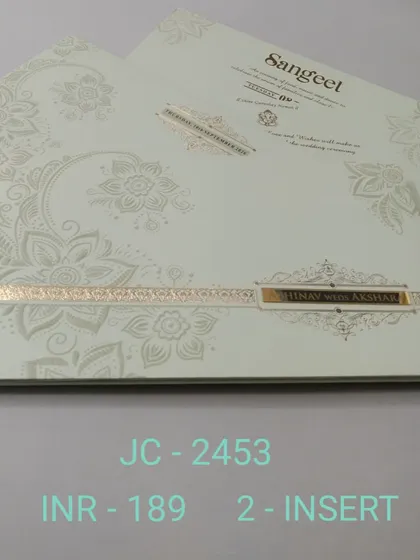 This off-white invitation features a modern, oversized floral pattern embossed in a pearl finish. A simple gold band with the couple's names completes this chic and contemporary design.