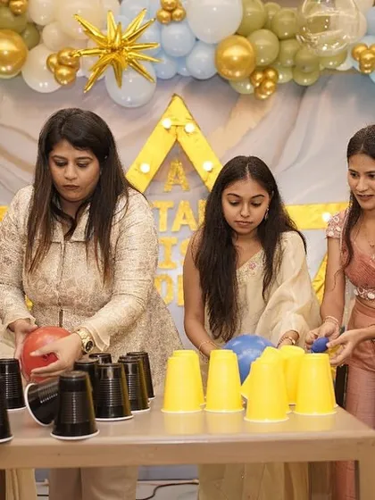 A cup-stacking game that requires teamwork and a steady hand. The guests are completely focused and having a great time.