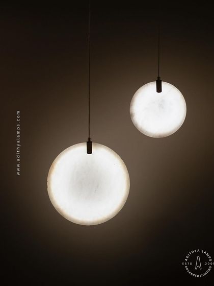 Showcasing our disc-shaped marble pendants. The light emanates softly through the thin slice of natural marble, revealing its unique veining. These fixtures are available in different shapes and look stunning hung in pairs or trios.