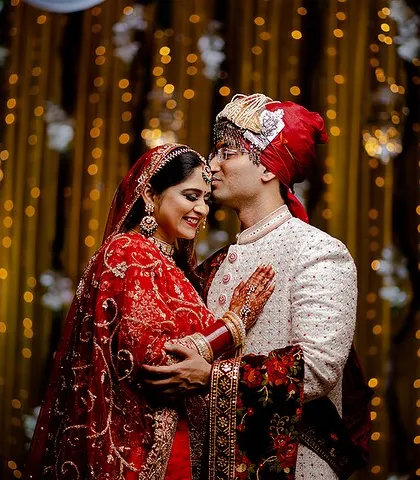 A tender forehead kiss against a glittering gold background. This portrait is the perfect blend of intimacy and glamour.