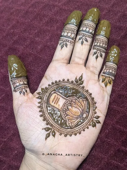 The fresh henna paste on the Mahadev mandala design. You can see the clean lines and the details within the central circle.