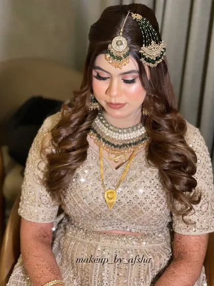 A full view of the look, showing the beautiful hairstyle with 3D lines in the front for added volume, as mentioned in the vlog for this bride.