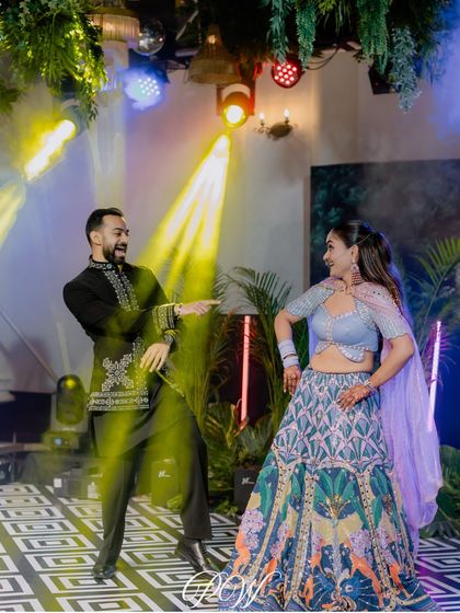 Dancing under the spotlight. We use dynamic lighting to create a club-like atmosphere, perfect for a high-energy Sangeet night where you can dance your heart out.