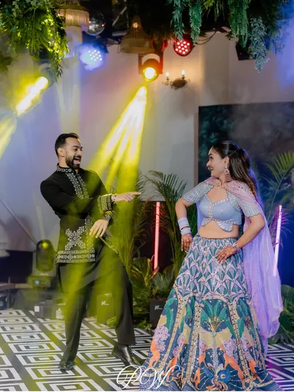 The couple showing off their moves under the vibrant lights of their Sangeet. We ensure the lighting design highlights the key moments, especially the couple's performance.