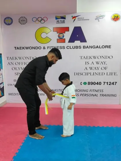Tying a yellow belt.