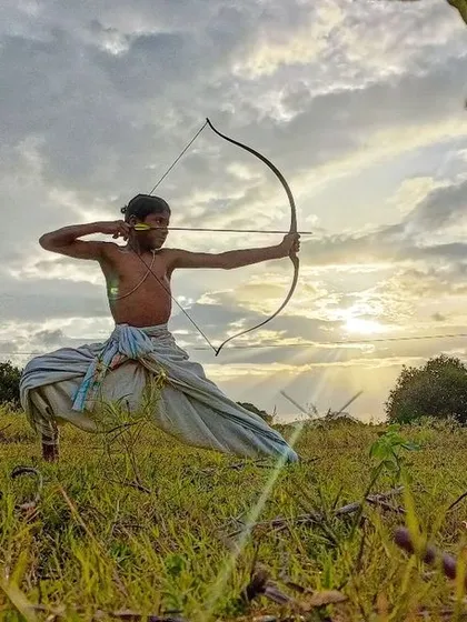 The true archer aims not just at the target, but at the perfection of their own form and focus. This young student demonstrates a powerful stance against the setting sun, a symbol of his growing inner light.
