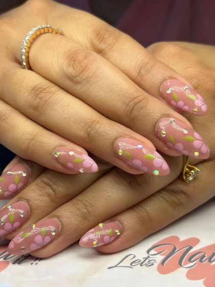 A sweet and delicate design with hand-painted pink flowers on a nude base, accented with tiny rhinestones.