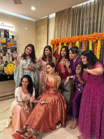 A fun group photo of the bride with her bride tribe, all celebrating the mehndi ceremony.