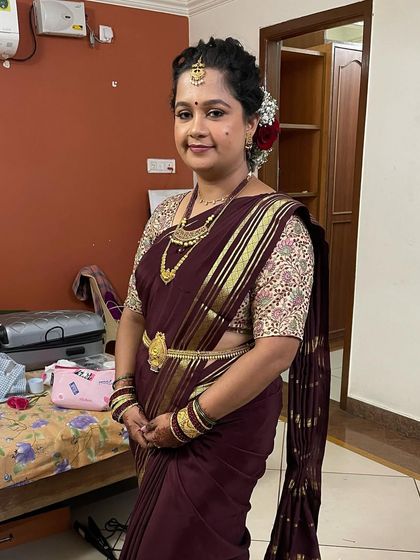 The full look for Swathi's Varpooja. The simple makeup and elegant hairstyle perfectly complement her beautiful maroon saree.