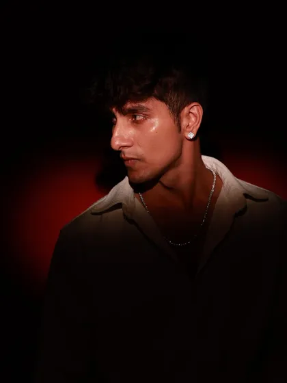 A profile shot of the male model, highlighting his jawline and the moody lighting.