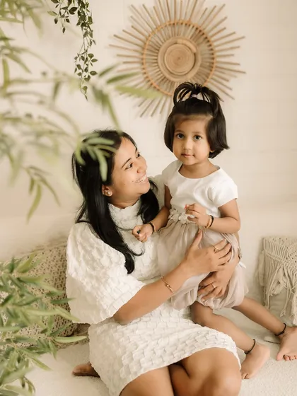 A beautiful mother-daughter portrait, capturing a quiet and loving moment.