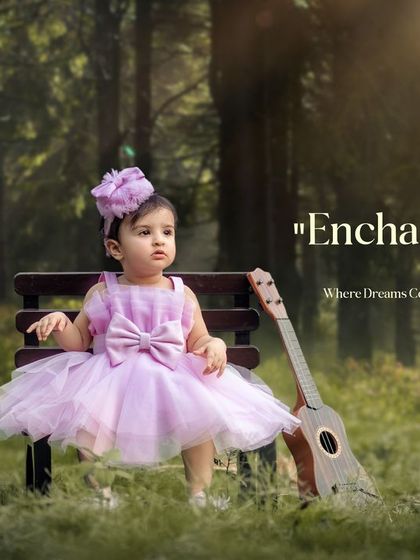 Enchanted childhood where dreams come to life. A little princess in a lavender dress sits with her guitar in a magical, sunlit forest.