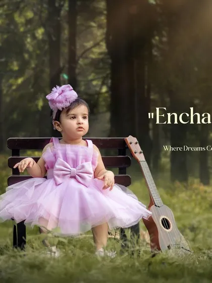 Enchanted childhood where dreams come to life. A little princess in a lavender dress sits with her guitar in a magical, sunlit forest.
