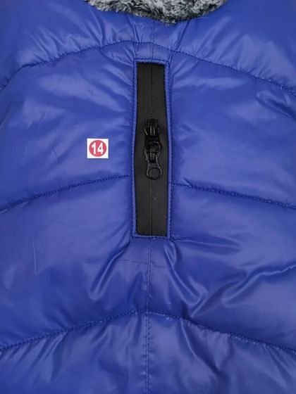 This blue puffer jacket for dogs is perfect for chilly weather. It features a convenient zipper for easy leash attachment through the back.