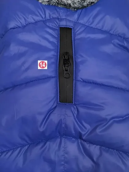 This blue puffer jacket for dogs is perfect for chilly weather. It features a convenient zipper for easy leash attachment through the back.