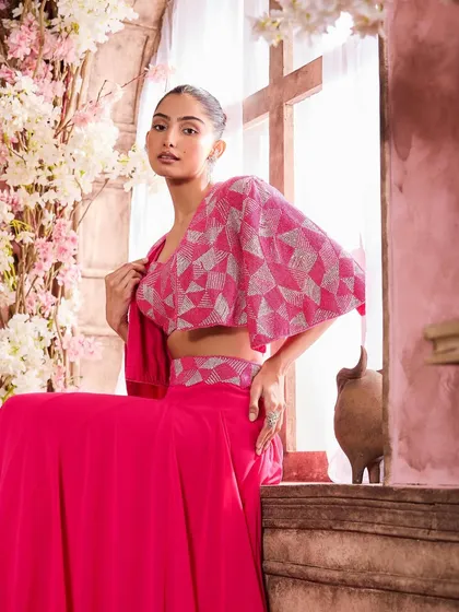 A model seated in a vibrant pink geometric-print outfit. I used a complementary pink blush and a soft lip color to tie the whole look together.