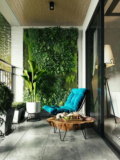 This cozy balcony uses a vertical garden to create a lush backdrop. The comfortable lounge chair and natural wood table make it the perfect spot for reading or enjoying a cup of tea.