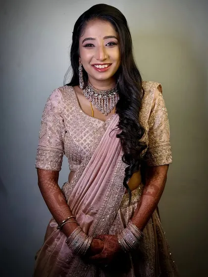 For Tina's reception, we went for a soft glam look that was both elegant and fun. Her happiness shines through in this beautiful pink lehenga, and the makeup was designed to last through a whole night of celebration.