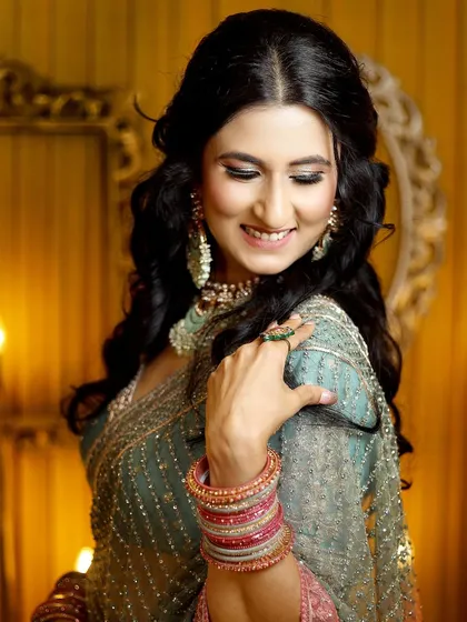 A graceful pose showing the bride-to-be's elegance and the intricate details of her engagement outfit and jewelry.